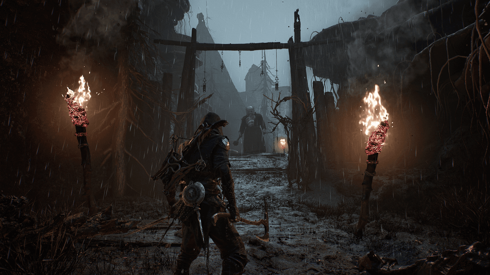 An armed warrior faces a figure along a rain-soaked passage between burning torches in Mortal Shell II.